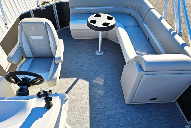 Slide: The Image of 2026 Godfrey Experience 2086 BFX boat interior with plush seating and steering console. - 4