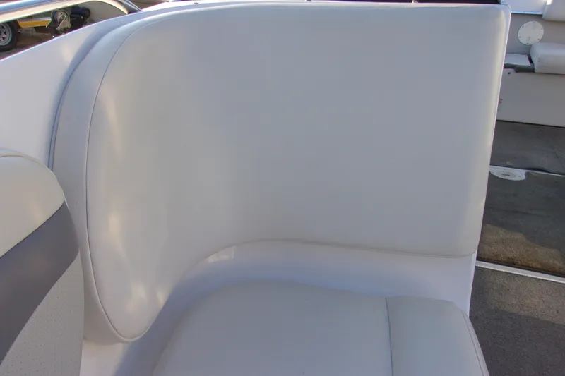 Slide: The Image of 2007 Chaparral 210 SSi boat interior with white cushioned seating. - 11