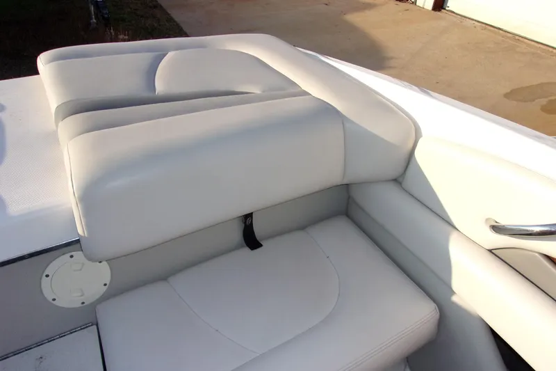 Slide: The Image of 2007 Chaparral 210 SSi boat interior with white cushioned seating. - 14