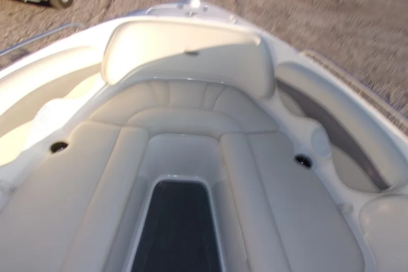 Slide: The Image of 2007 Chaparral 210 SSi boat interior with cushioned seating and cup holders. - 9
