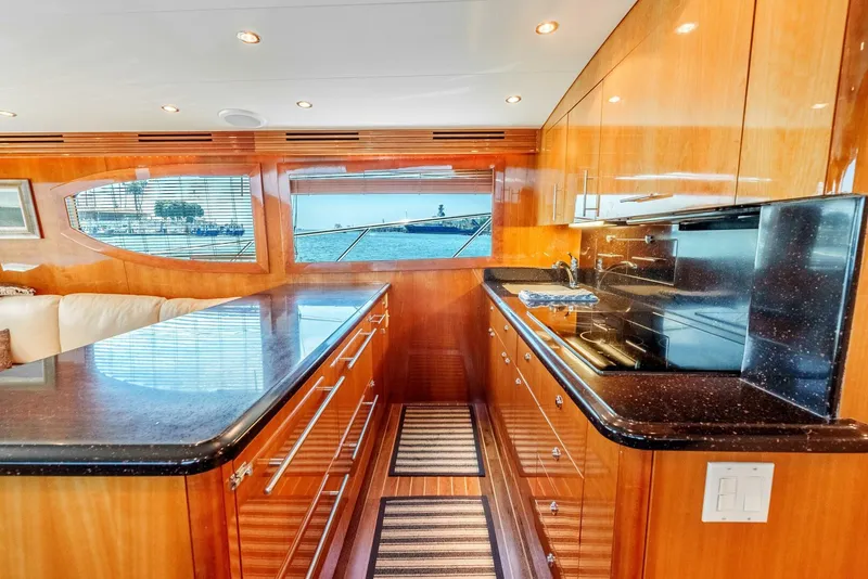 Slide: The Image of Luxurious kitchen interior of 2004 Hatteras 54 Convertible yacht with sleek wood cabinetry. - 13
