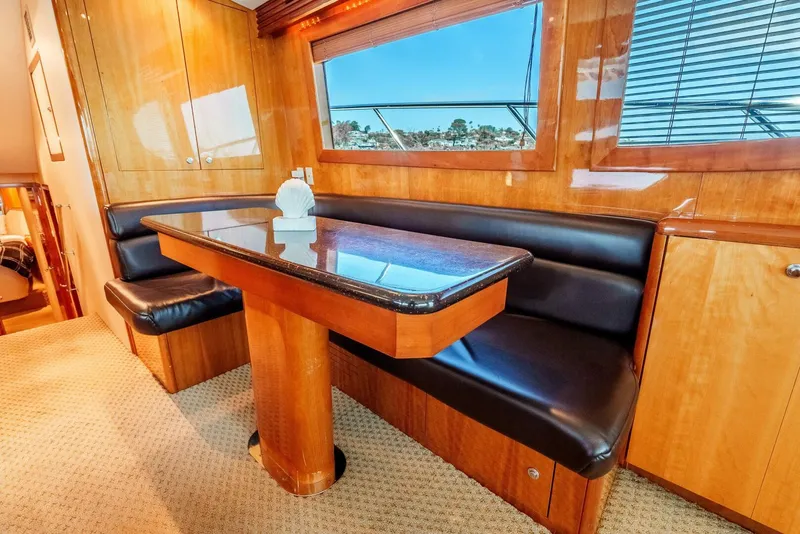 Slide: The Image of Luxurious interior of 2004 Hatteras 54 Convertible yacht with elegant dining area. - 15