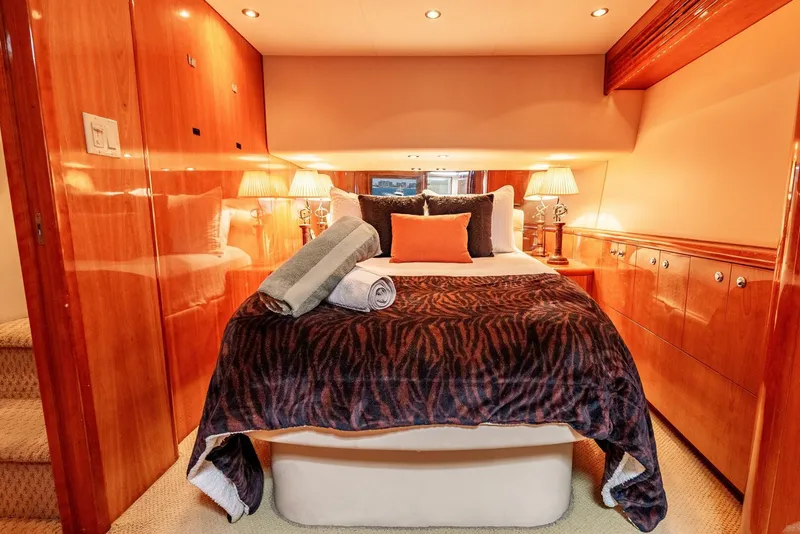 Slide: The Image of Luxurious bedroom interior of 2004 Hatteras 54 Convertible yacht with elegant wood paneling. - 17