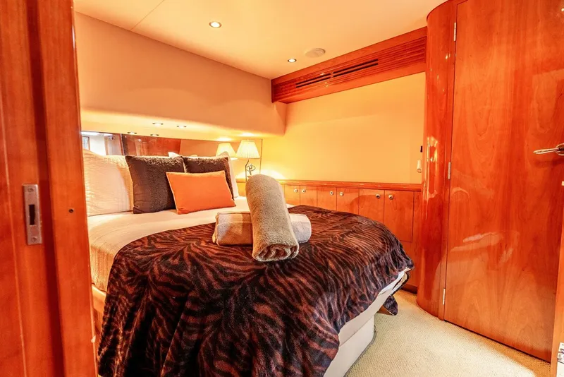 Slide: The Image of Luxurious bedroom interior of 2004 Hatteras 54 Convertible yacht with elegant wood finishes. - 18