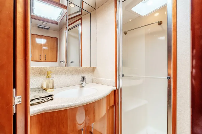 Slide: The Image of Luxurious bathroom in 2004 Hatteras 54 Convertible yacht with modern fixtures and elegant design. - 20