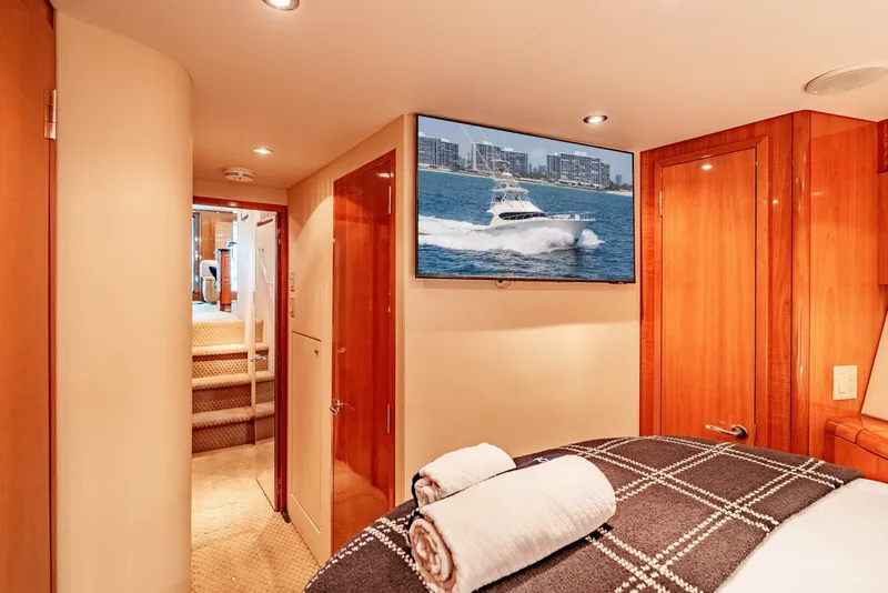 Slide: The Image of Luxurious interior of 2004 Hatteras 54 Convertible yacht with cozy bedroom and TV. - 22
