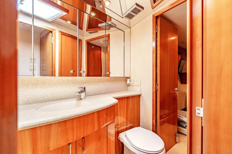 Slide: The Image of Luxurious bathroom in 2004 Hatteras 54 Convertible yacht with wood cabinetry and modern fixtures. - 23