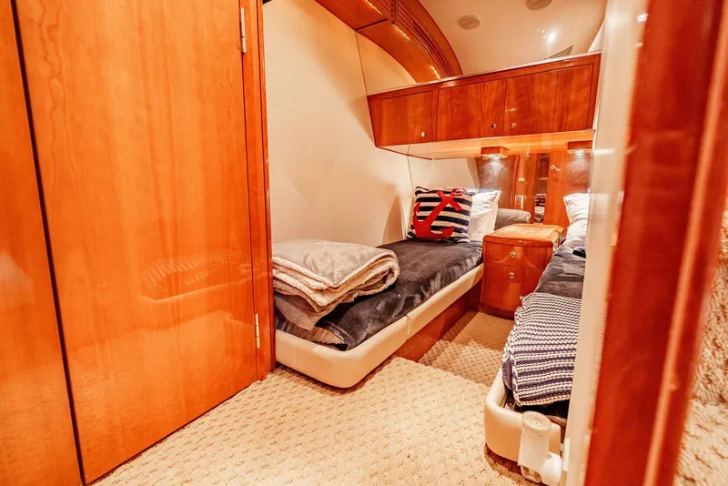 Slide: The Image of Luxurious cabin interior of 2004 Hatteras 54 Convertible yacht with twin beds and wooden finish. - 26