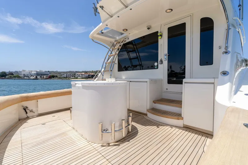 Slide: The Image of 2004 Hatteras 54 Convertible yacht deck with ocean view and sleek design. - 29
