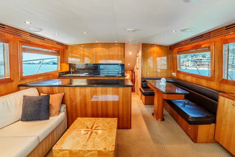 Slide: The Image of Luxurious interior of 2004 Hatteras 54 Convertible yacht with elegant wood finishes and seating. - 3
