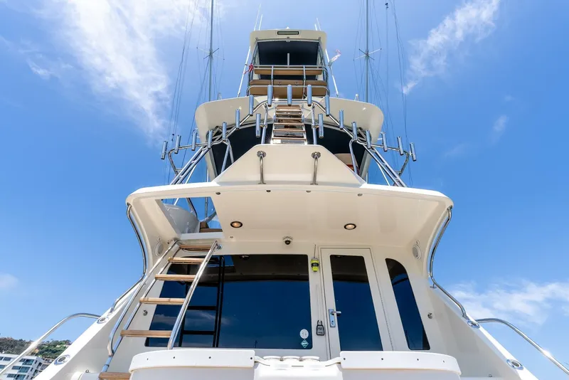 Slide: The Image of 2004 Hatteras 54 Convertible yacht, viewed from below against a clear blue sky. - 31