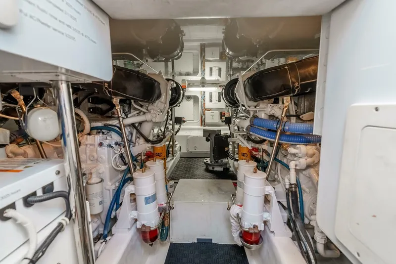 Slide: The Image of Engine room of a 2004 Hatteras 54 Convertible yacht, showcasing dual engines and mechanical systems. - 41