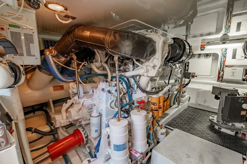 Slide: The Image of Engine room of 2004 Hatteras 54 Convertible yacht, showcasing complex machinery and components. - 42