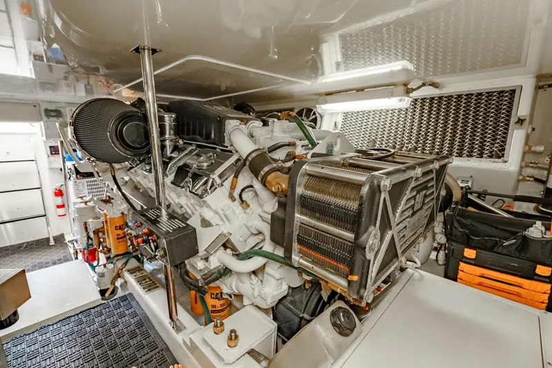 Slide: The Image of Engine room of 2004 Hatteras 54 Convertible yacht, featuring a powerful marine engine. - 44