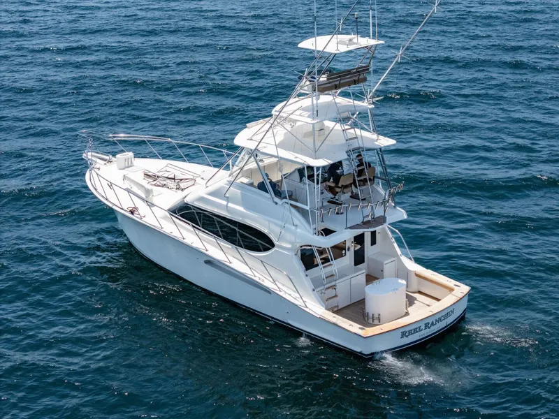 Slide: The Image of 2004 Hatteras 54 Convertible yacht cruising on open water. - 48