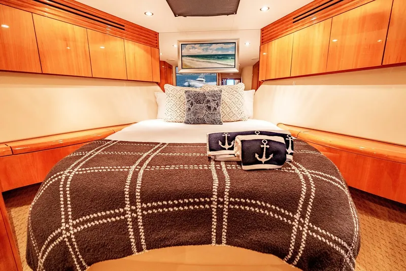 Slide: The Image of Luxurious cabin interior of 2004 Hatteras 54 Convertible yacht with elegant bedding and wood finishes. - 5