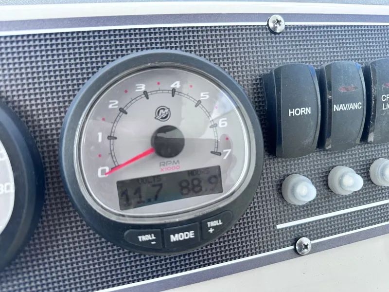Slide: The Image of Dashboard of 2023 Boston Whaler 210 Montauk with tachometer and switches. - 16