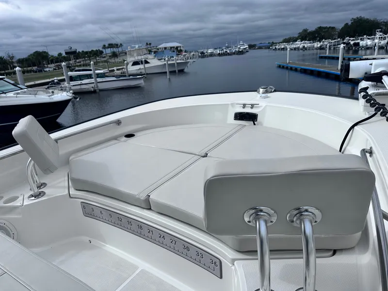 Slide: The Image of 2023 Boston Whaler 210 Montauk in harbor, featuring comfortable seating area. - 18