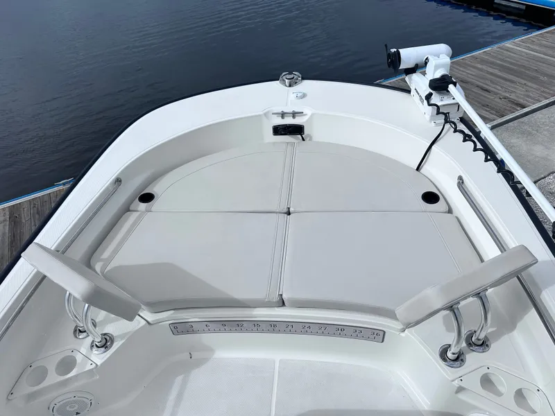 Slide: The Image of Boston Whaler 210 Montauk 2023 with cushioned bow area at dock. - 19
