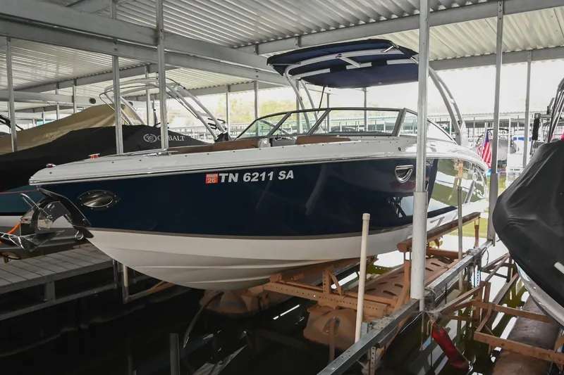 The Image of 2015 Cobalt R7 boat docked in a covered marina, side view. - 0