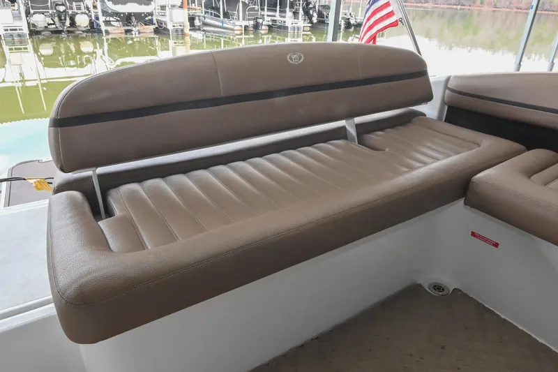 Slide: The Image of 2015 Cobalt R7 boat interior with brown leather seating and American flag in background. - 11