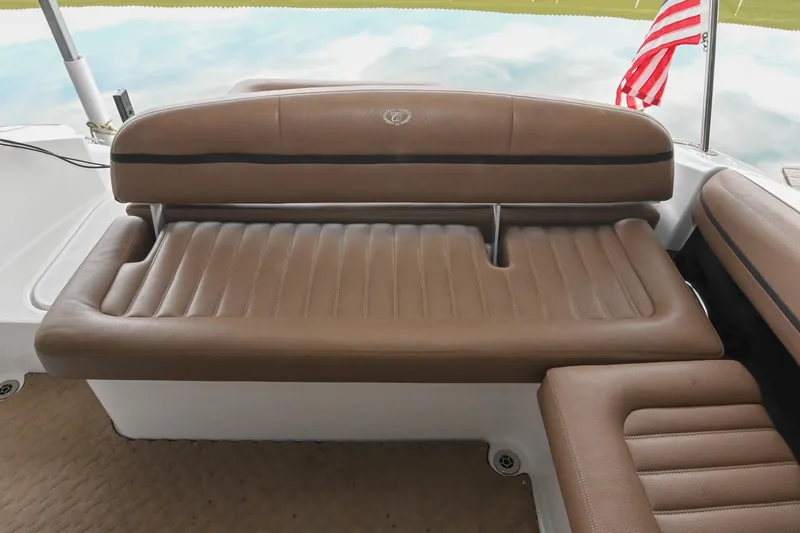 Slide: The Image of 2015 Cobalt R7 boat with brown leather seating and American flag in the background. - 12