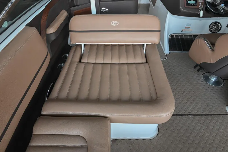 Slide: The Image of 2015 Cobalt R7 boat interior with brown leather seating and modern dashboard. - 16