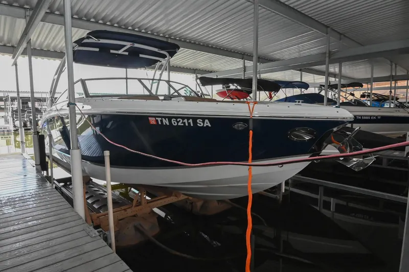 Slide: The Image of 2015 Cobalt R7 boat docked in a covered marina. - 2