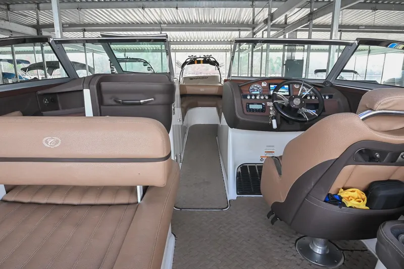 Slide: The Image of Interior of a 2015 Cobalt R7 boat with brown leather seating and modern dashboard. - 20