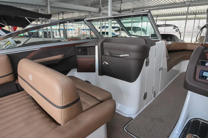 Slide: The Image of 2015 Cobalt R7 boat interior with brown leather seating and modern dashboard. - 21