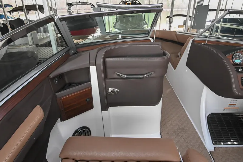 Slide: The Image of Interior of a 2015 Cobalt R7 boat, featuring brown leather seating and sleek dashboard design. - 22