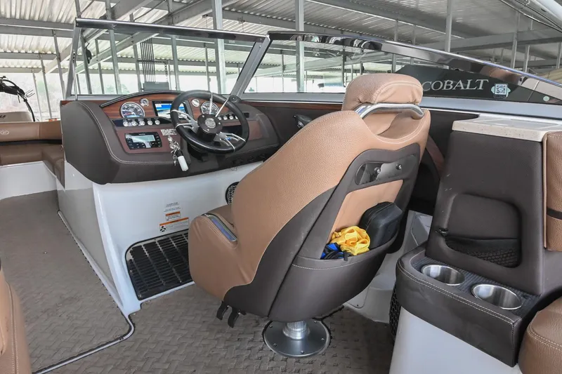 Slide: The Image of 2015 Cobalt R7 boat interior with brown leather seats and modern dashboard controls. - 25