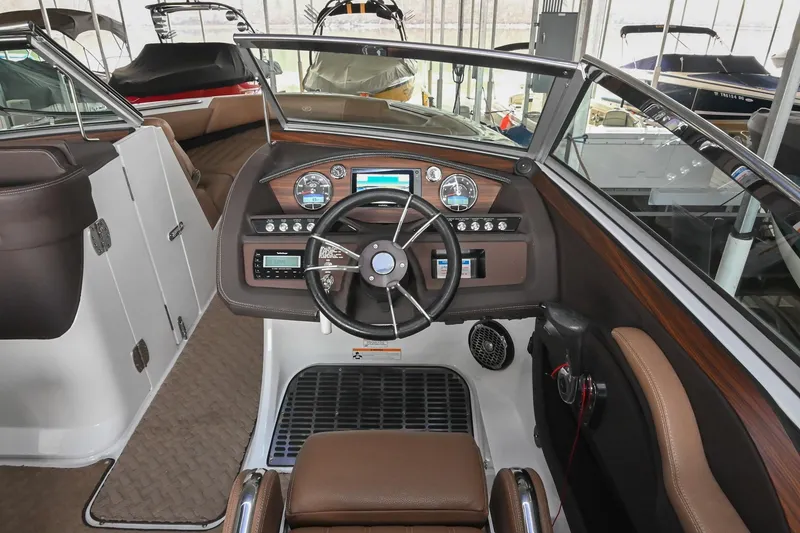 Slide: The Image of Interior of a 2015 Cobalt R7 boat with steering wheel and dashboard controls. - 26
