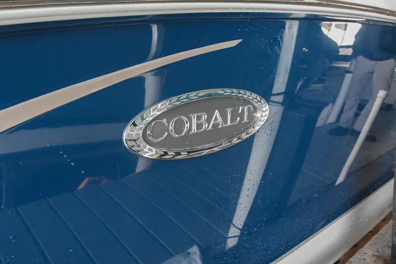 Slide: The Image of 2015 Cobalt R7 boat with blue exterior and chrome logo detail. - 3