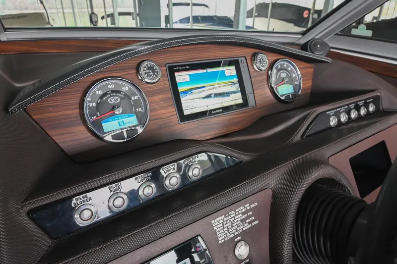 Slide: The Image of Dashboard of a 2015 Cobalt R7 boat with gauges and Garmin display. - 30