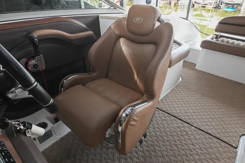 Slide: The Image of Captain's chair in 2015 Cobalt R7 boat interior, featuring brown leather and chrome accents. - 33
