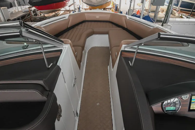 Slide: The Image of 2015 Cobalt R7 boat interior with brown seating and dashboard view. - 34