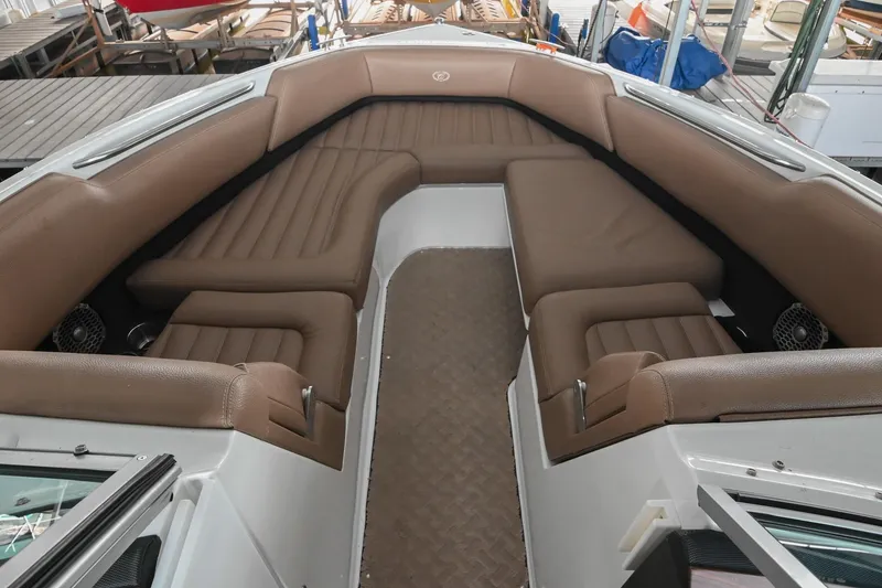 Slide: The Image of 2015 Cobalt R7 boat interior with brown seating and spacious layout. - 35