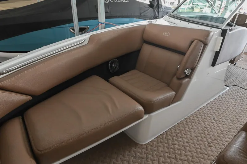 Slide: The Image of 2015 Cobalt R7 boat interior with brown leather seating and carpeted flooring. - 38