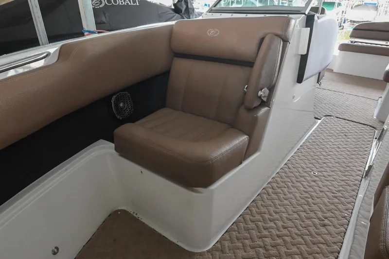 Slide: The Image of 2015 Cobalt R7 boat interior with brown leather seating and carpeted flooring. - 39