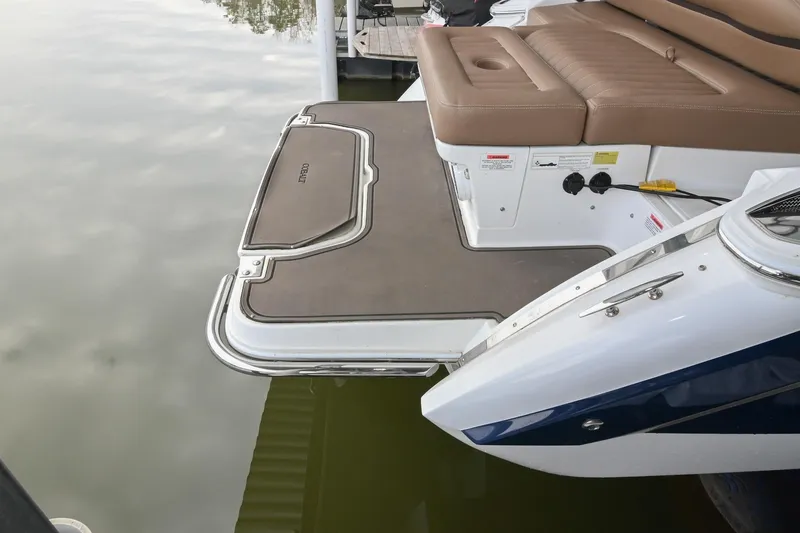 Slide: The Image of 2015 Cobalt R7 boat with brown seating and swim platform on calm water. - 4