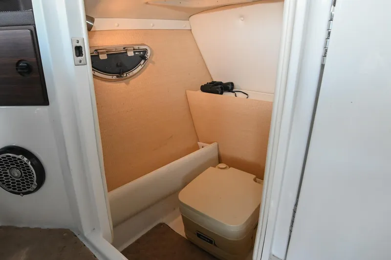 Slide: The Image of 2015 Cobalt R7 boat interior with compact toilet and storage space. - 42