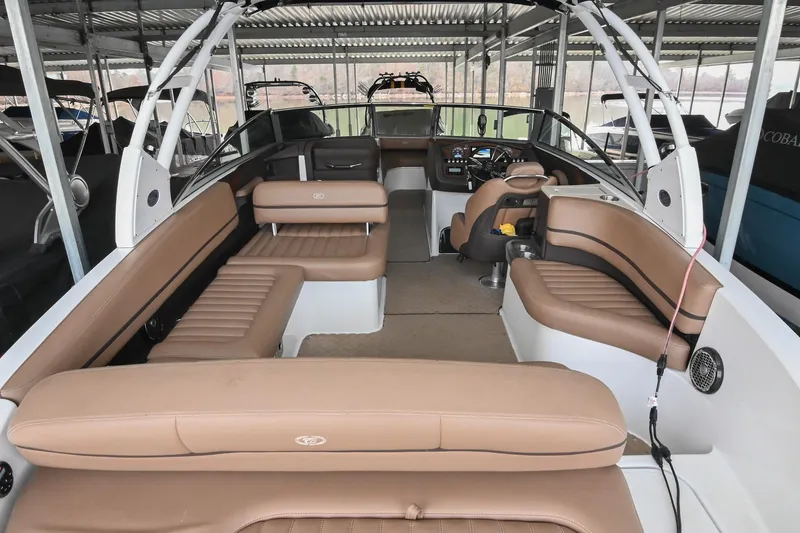 Slide: The Image of 2015 Cobalt R7 boat interior with tan leather seating and modern dashboard. - 5
