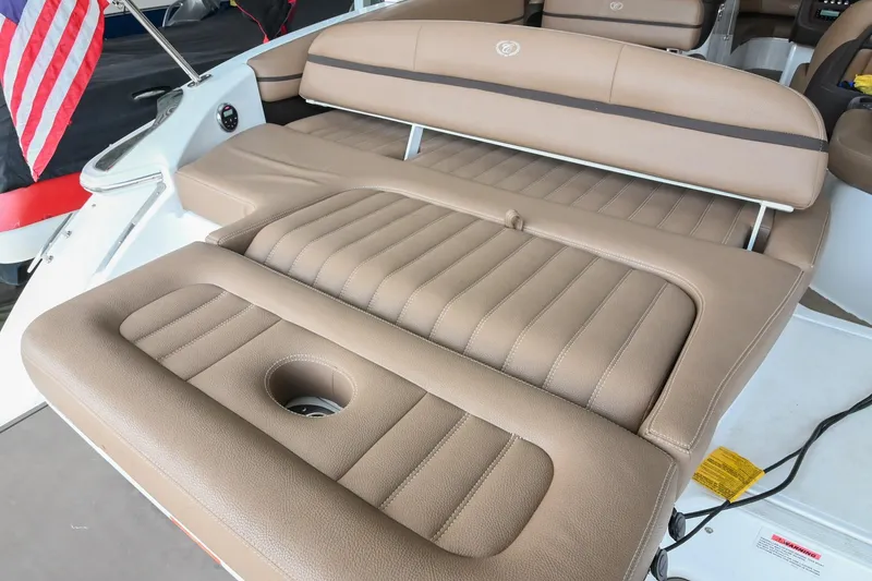 Slide: The Image of 2015 Cobalt R7 boat with tan leather seating and cup holder, featuring American flag. - 6
