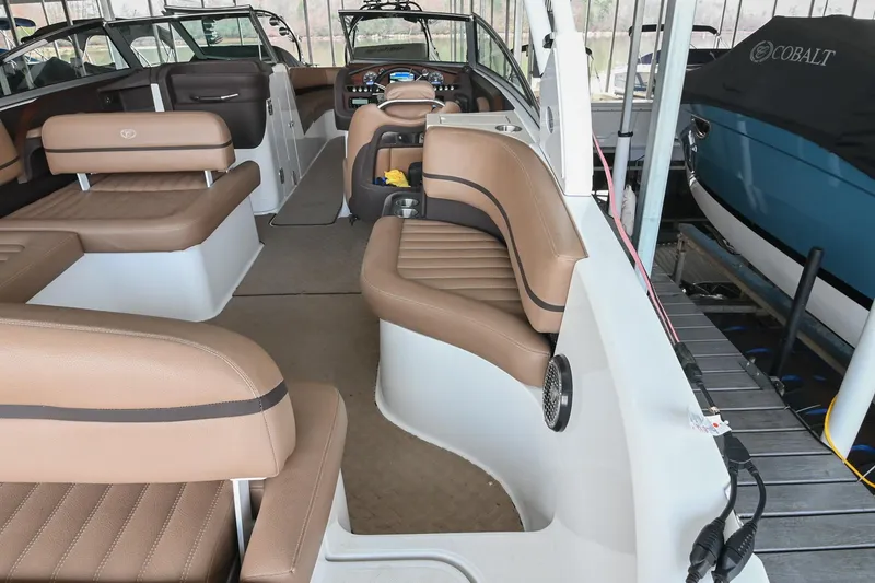 Slide: The Image of Interior of a 2015 Cobalt R7 boat with tan leather seating and modern dashboard. - 9