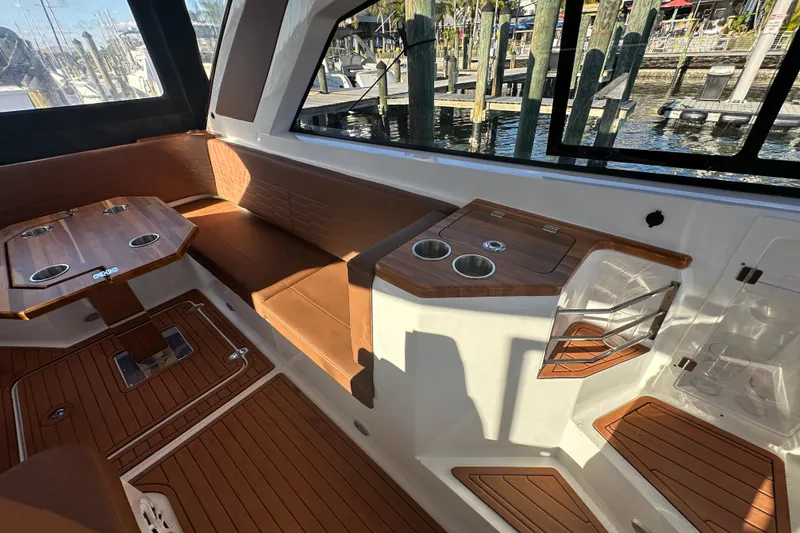 Slide: The Image of Luxurious interior of 2025 NX Boats 370 with wood accents and seating area. - 100