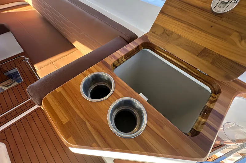 Slide: The Image of Luxury wooden boat interior with cup holders and storage, NX Boats 370, 2025 model. - 101