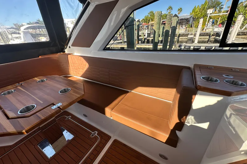 Slide: The Image of Luxurious interior of 2025 NX Boats 370 with elegant seating and wooden table. - 104