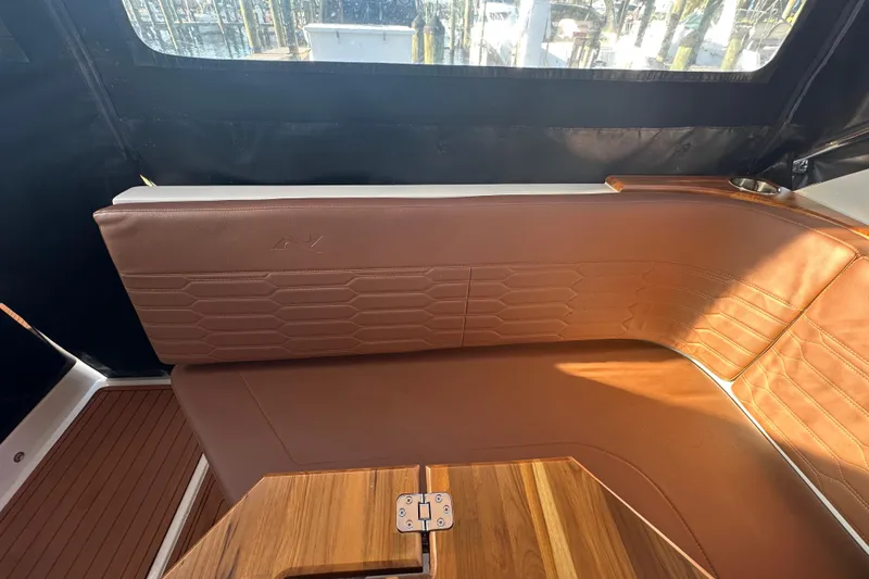 Slide: The Image of Luxurious brown leather seating in 2025 NX Boats 370 interior, featuring elegant wood accents. - 109