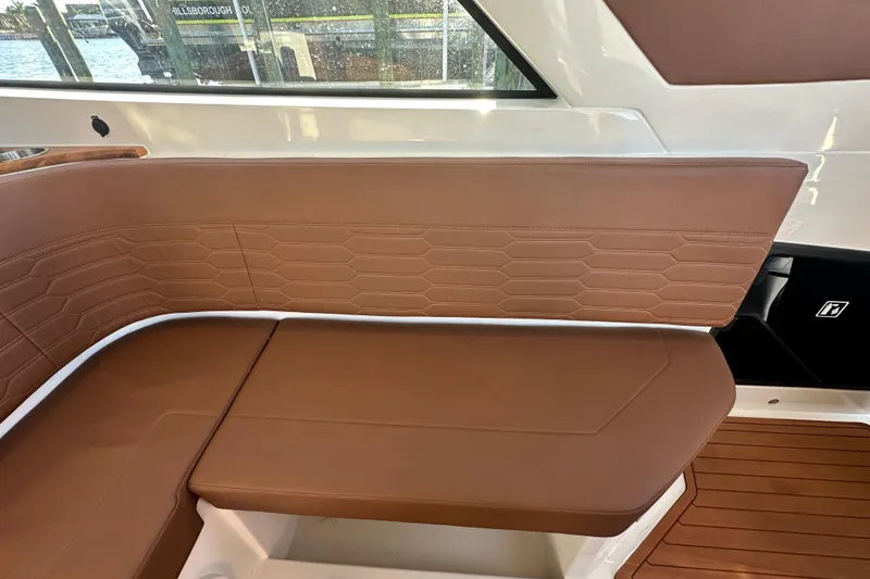 Slide: The Image of Luxurious brown seating on 2025 NX Boats 370, featuring elegant stitching and modern design. - 114